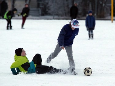 Students at Victoria School in the first snowfall in Saskatoon, November 18, 2015.