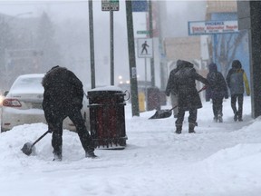 Shovelers tried to keep their sidewalks clear of snow in the 900 block of 20th Street West on Nov. 24, 2015 in Saskatoon.