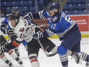 Saskatoon Blades Anthony Bishop versus Calgary Hitmen Beck Malenstyn on Nov. 25, 2015 in Saskatoon.