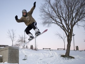 Cale Ochitwa jumps at River Landing on November 27, 2015 in Saskatoon. He and his Barely crew try to find urban terrain that they can turn into snowboard parks with some shovelling and building of ramps.