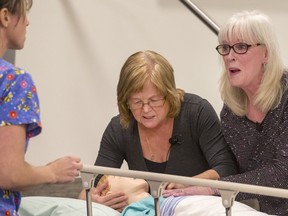 Family members react to a nurse's mistake in a dramatized simulation to demonstrate the Safety Alert System
