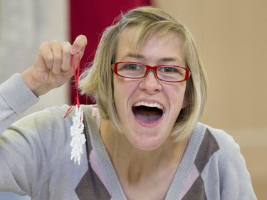 SASKATOON, SASK.; NOVEMBER  12, 2015 - 9999 features special   -  (BestPhoto) Tammy Stevens is all smiles after finishing her snowflake decoration with the theme sport of equestrian. Special Olympic Athletes spent the afternoon cutting, drawing and glueing hand made tree decorations before placing them on the tree bound for the 2015 City Hospital Foundation's Festival of Trees at the WDM, November 12, 2015. All decoration represented the sports the participant are involved in. Volunteer parents and high school students from Holy Cross and Bishop James Mahoney High Schools also spent the afternoon helping out. (GORD WALDNER/Saskatoon StarPhoenix)