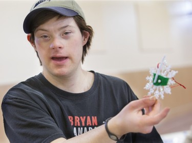 Ben Shear shows off his province of Saskatchewan shaped decoration at decorating bee where Special Olympic Athletes spent the afternoon cutting, drawing and glueing hand made tree decorations before placing them on the tree bound for the 2015 City Hospital Foundation's Festival of Trees at the WDM, November 12, 2015. All decoration represented the sports the participant are involved in. Volunteer parents and high school students from Holy Cross and Bishop James Mahoney High Schools also spent the afternoon helping out.