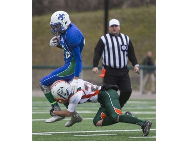 Moose Jaw Peacock Tornadoes' Mark Warburton tackles Saskatoon Bishop Mahoney Saints' Taijal Verma in 3A Football Provincial finals at SMS field in Saskatoon, November 14, 2015.