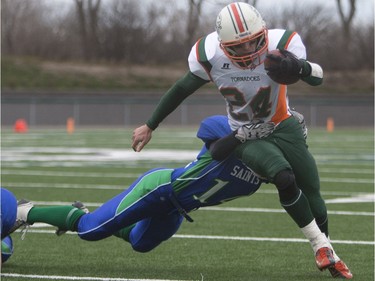 Moose Jaw Peacock Tornadoes' Kyle Arndt runs the ball against the Saskatoon Bishop Mahoney Saints in 3A Football Provincial finals at SMS field in Saskatoon, November 14, 2015.