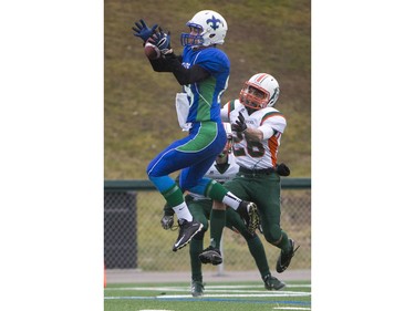 Moose Jaw Peacock Tornadoes' Mark Warburton tackles Saskatoon Bishop Mahoney Saints' Kobe Peppler in 3A Football Provincial finals at SMS field in Saskatoon, November 14, 2015.