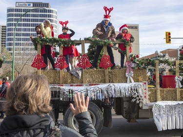 Members of the Salvation Army float wave as the Santa Claus parade makes its way down Second Avenue North in Saskatoon, November 15, 2015.