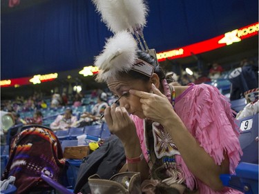 Michelle Kipp puts on make-up during the Federation of Saskatchewan Indian Nations (FSIN) Cultural Celebration and Pow Wow at SaskTel Centre in Saskatoon, November 15, 2015.