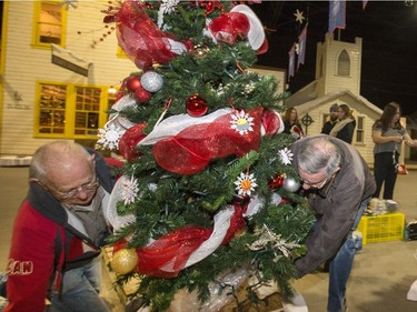 Volunteers at the Western Development Museum, site of the annual Festival of Trees sets up the finished Saskatoon Special Olympics tree in its place, Nov 19, 2015. Olympian participants decorated the tree with hand made ornaments. The tree was one of the first setup and ready for the 2015 opening.