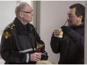 Saskatoon Police Chief Clive Weighill speaks with a person prior to a media event announcing expansions to the Lighthouse shelter on Friday, November 20th, 2015.