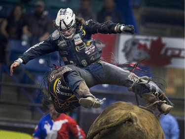 Stetson Lawrence is airborne off the bull Shakin Hands after a ride at the PBR Canadian Finals Bull Riding  in Saskatoon at SaskTel Centre, Friday, Nov. 20, 2015.