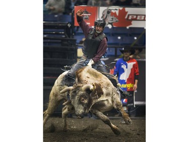 Tim Lippsett with a 80.5 for this ride on Lincoln the bull at the PBR Canadian Finals Bull Riding in Saskatoon at SaskTel Centre, Friday, Nov. 20, 2015.