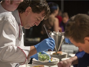 A chef prepares a plate at  the Gold Medal Plates Dinner at Prairieland Park, Friday, Nov. 20, 2015.