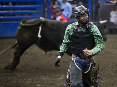 Brady Oleson celebrates after riding a bull during the Professional Bull Riding PBR Canadian finals at SaskTel Centre in Saskatoon, November 21, 2015.