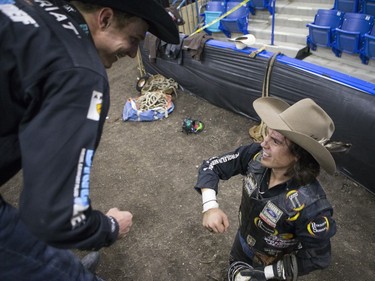 Stetson Lawrence (R) is congratulated after riding the bull Hard Rock during the Professional Bull Riding PBR Canadian finals at SaskTel Centre in Saskatoon, November 21, 2015.