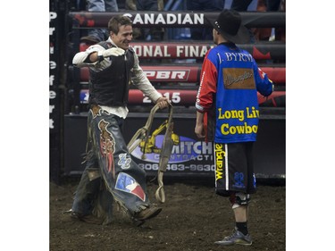 Zane Lambert celebrates after riding the bull Come Closer during the Professional Bull Riding PBR Canadian finals at SaskTel Centre in Saskatoon, November 21, 2015.