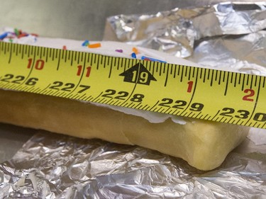 Nestor's Bakery and students of the Community Learner's High School are attempting to make the world's longest long john donut, and it measured in at over 19' 1 1/2", November 24, 2015. Keith Jorgensen with helpers Randy Shaw, Anna Weird, Janet Neu, Tom Carey and Carmen Dyck all participated.