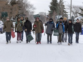 Josh Weibe's Wellness 10 class with the help of intern Andrew Abbs were just finishing up class shovelling snow off of sidewalks and driveways in the area of the 300 block of Avenue U and V North "giving a little bit back to the community," November 25, 2015.