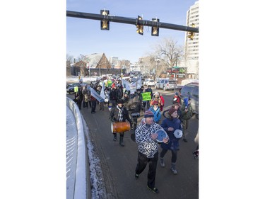 People walk down the Broadway Bridge during a march and rally for the climate called Saskatoon2Paris, November 29, 2015.