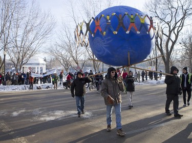 People walk down 20th Street East during a march and rally for the climate called Saskatoon2Paris, November 29, 2015.