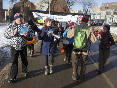 People walk down the Broadway Bridge during a march and rally for the climate called Saskatoon2Paris, November 29, 2015.