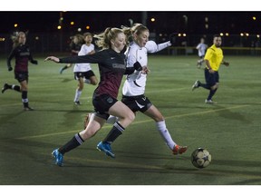 St.Joseph Guardian #10 Jordan Zemlak and Centennial Chargers #5Jesse MacDonald chase down the ball along the sidelines in the Saskatoon High School Girls Soccer final, October 26, 2015.