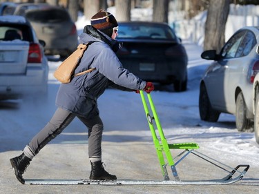 Jenni Willems, a chef at Station 20 West, zips along on the snow along 20th Street West on her "Sparka" or Norwegian kick sled, February 25, 2015. Willems said she can travel from the 1100 block of 20th Street West to the Rotary Park area in about 14 minutes under her own steam.