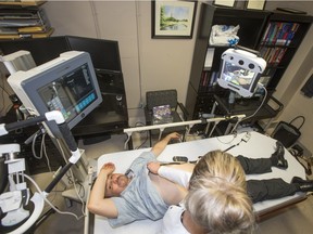 Licensed practical nurse Cheri Derkson and robotics engineer Luis Bustamante participate in a demonstration by Dr Ivar Mendez using robotic technology.