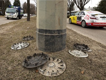 Vehicles drive past a ring of hubcaps in the 1600 block of Preston Avenue, April 15, 2015. With potholes on either side of the location, it is possible they came from unsuspecting drivers meeting Saskatoon roads.