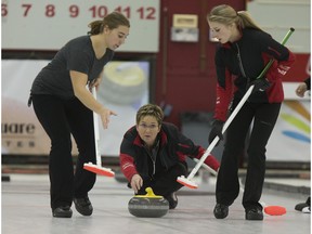 Skip Sherry Anderson throws a stone with sweepers Brie Spilchen, left and Elyse Lafrance in action during the Colonial Square Ladies Curling Classic championship final at the Nutana Curling Club, Monday, Nov. 09, 2015.