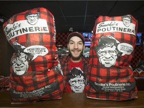 SASKATOON,SK--NOVEMBER 16/2015 1117 Business Poutine1  - Jason Evanochko, owner of Smoke's Poutinerie on 21st Street East downtown, with bags of potatoes used in the product , Monday, November 16, 2015. (GREG PENDER/ SASKATOON STARPHOENIX)