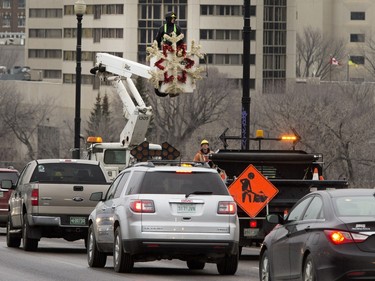 City employees hang Christmas decorations on Broadway Bridge in Saskatoon, November 16, 2015.