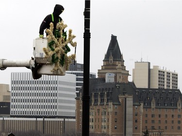 City employees hang Christmas decorations on Broadway Bridge in Saskatoon, November 16, 2015.