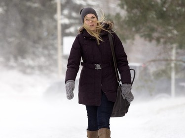 Courtney Tkachuk endures the wind and blowing snow while walking on the University of Saskatchewan campus,  November 18, 2015.