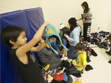 Students from St. Michael School dove right in during the annual Coats for Kids news conference at the school, November 19, 2015. Hundreds of coats and warm winter accessories were collected through the Rock 102 Coats for Kids Campaign this year.