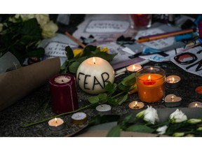 Candles at the entrance to Le Carillon restaurant in Paris after a series of terrorist attacks in the French capital.