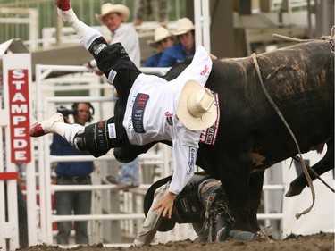 Tyler Pankewitz of Warburg, AB. tangles with Tattoo while one of the bullfighters tries to get in between them at the Calgary Stampede in 2008.