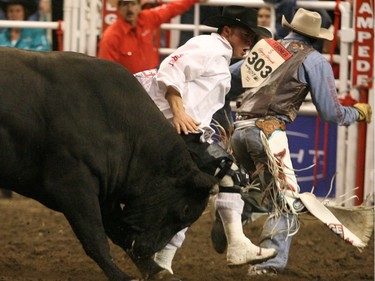 Bullfighter Scott Bryne gets between Jody Turner of Coachran, Alta. and a bull named High Voltage  at the  Canadian Rodeo Tour Championship in Calgary in 2008.