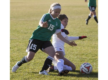 University of Saskatchewan Huskies midfielder Erica Hindmarsh battles for the ball with University of Calgary Dinos midfielder Kayla Kreutzer during the first half of CIS women's soccer playoff action, November 8, 2015.