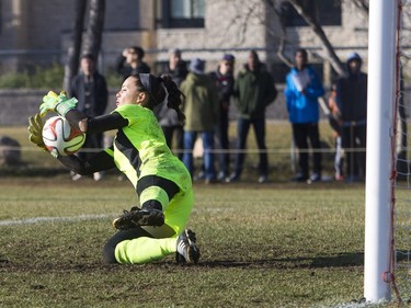 University of Calgary Dinos goalkeeper Samantha Chang-Foidl stops a shot from the University of Saskatchewan Huskies during the first half of CIS women's soccer playoff action, November 8, 2015.