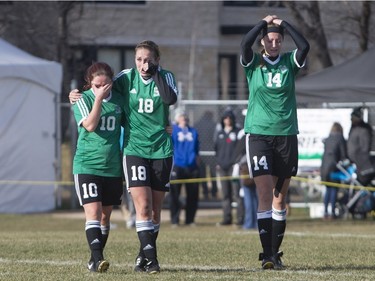 L-R: University of Saskatchewan Huskies midfielder Kelly Cerkowniak, defender Erica Parenteau, and defender Jennifer Miller leave the field after the University of Calgary Dinos defeat the Huskies in CIS women's soccer playoff action, November 8, 2015.