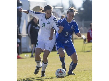 University of Saskatchewan Huskies' Julianne Labach battles for the ball against University of Lethbridge Pronghorns' Morag Paterson in CIS Women's Soccer playoff action, October 31, 2015.