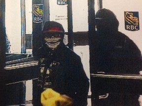 An image taken from surveillance video shows Colin Kaiswatum entering the Royal Bank on Worobetz Place on May 12, 2014, during an armed robbery.