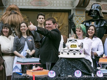 Australian Star Wars fans, Andrew Porters and Caroline Ritter get married at the forecourt of Hollywood's TCL Chinese Theater IMAX in Los Angeles Thursday, Dec. 17, 2015. The couple stood alongside a wedding party of "Star Wars" characters, including Chewbacca, top left, and Darth Vader, top right.