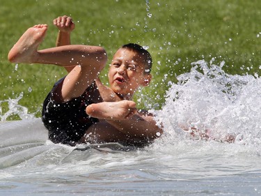 The Saskatoon Fire Department set up a slip and slide in John Lake Park on July 21, 2015. Approximately 200 children showed up for the event.