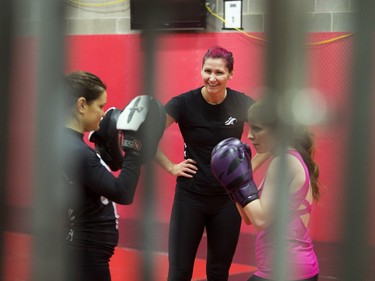 Charmaine Tweet, centre, professional mixed martial artist teaches a womenÕs self-defence class to Alexandra Markou, left, and Kat Duncombe at Alliance Training Center on Sunday, December 13th, 2015.