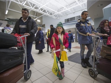 Syrian refugees arrive at the Saskatoon airport on December 19, 2015.