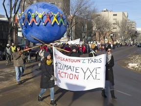 Pasrticipants walk down Broadway Bridge during the Saskatoon2Paris rally on Nov. 29, 2015.