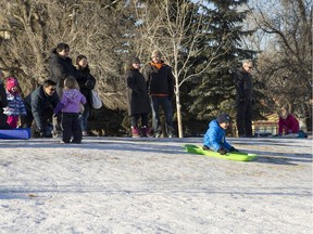 People slide down a small hill and are on the scene at Winterlude behind Victoria School on Saturday, Dec. 5th, 2015.