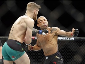 Conor McGregor knocks out  Jose Aldo during a featherweight championship mixed martial arts bout at UFC 194, Saturday, Dec. 12, 2015, in Las Vegas.